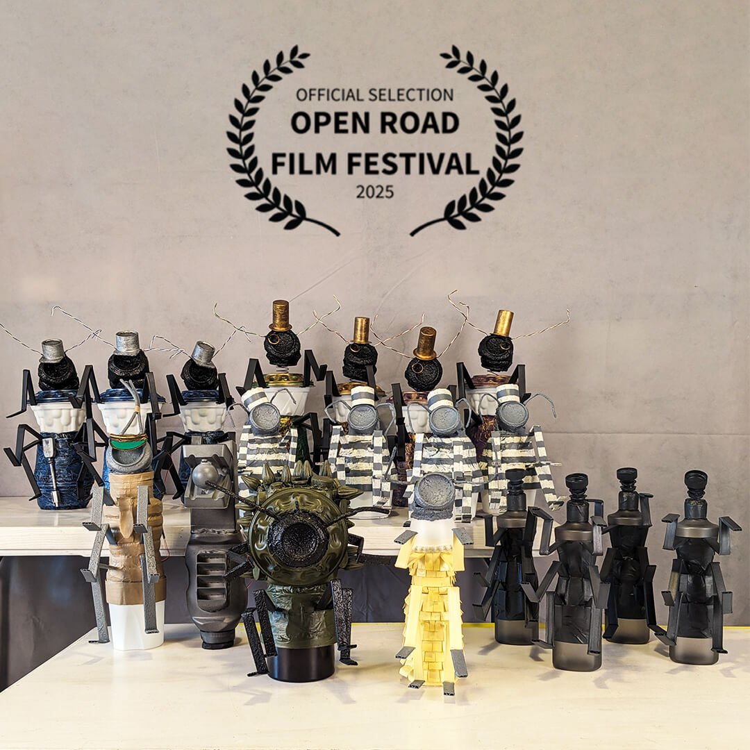 A photo of the entire puppet cast from the opera film "Red Flag of the Future" with laurels indicating the movie was selected for the Open Road Film Festival.